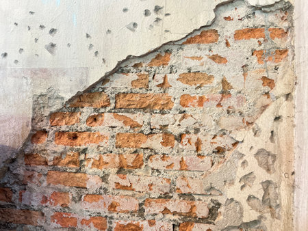 Old brick wall with peeling paint. Abstract background for design.の写真素材