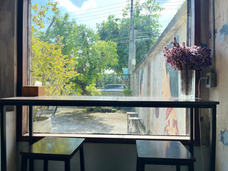 Table and chairs in a cafe with a view of the street.の写真素材