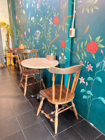 Interior of a restaurant with wooden chairs, tables and decorative wallの写真素材