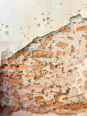 Old brick wall with peeling plaster. Abstract background and texture for design.の写真素材