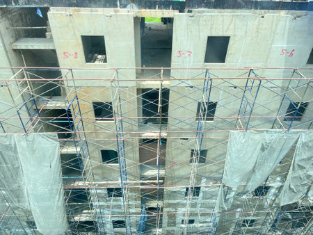 Construction site with scaffolding and building under construction, closeup of photoの写真素材