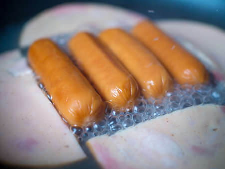 Fried hot dog ham on panの写真素材