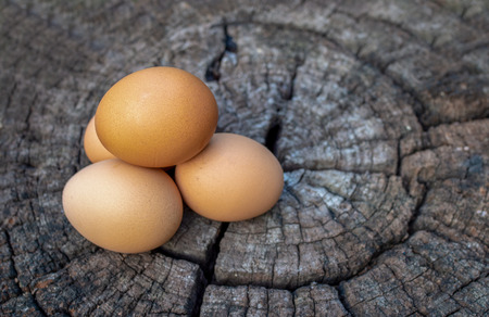 group of eggs on old brown wooden floorsの写真素材