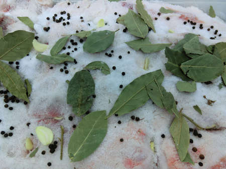 Salted bacon with bay leaf and spicesの写真素材