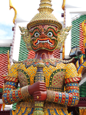 Statue of a giant Thai standing in the Emerald Buddha, Bangkok, Thailand.の写真素材