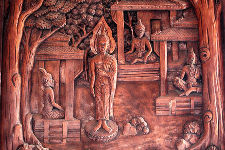 Buddha image carved on a wooden temple in Thailand.のeditorial素材