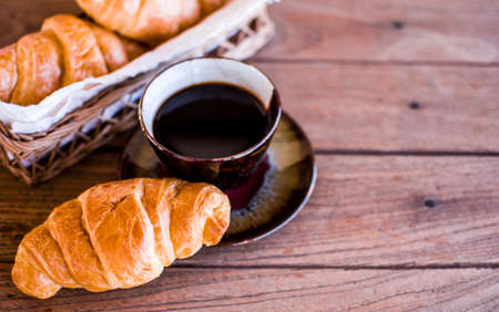 Freshly croissant on wooden background. It is a type of French pastry suitable as breakfast. It can be purchased at bakery worldwide.の写真素材