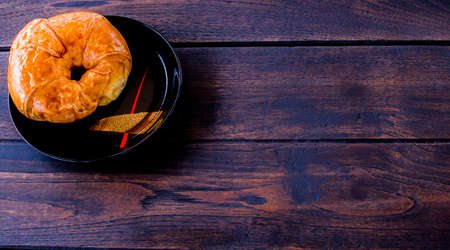 Freshly croissant on wooden background. It is a type of French pastry suitable as breakfast. It can be purchased at bakery worldwide.の写真素材