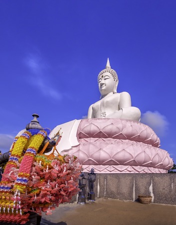 The Buddha made of pink petals. Cut with a beautiful cloudy skyの写真素材