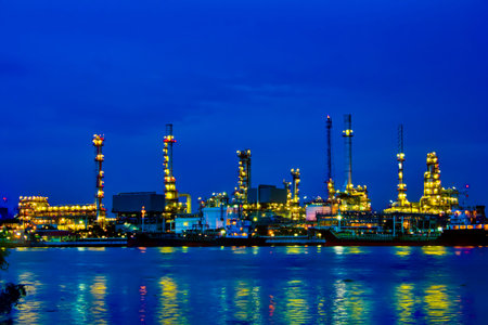 Oil refinery reflected chao pra ya rever at twilightの写真素材