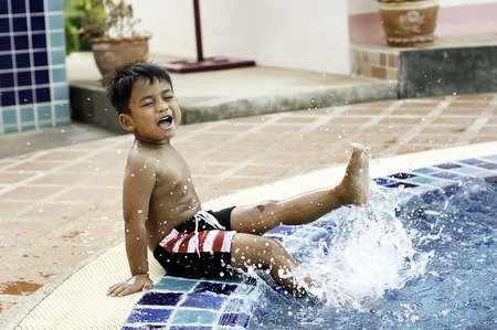 Activities on the pool, children swimming and playing in water, happiness and summertimeの写真素材