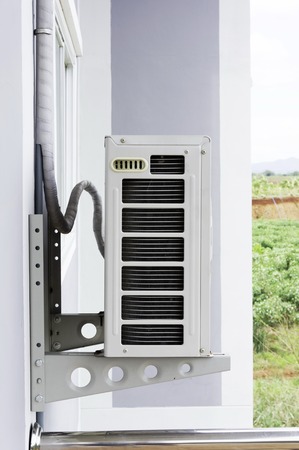 Home air conditioner In Asia, many Because hot air hanging on tall buildingsの写真素材