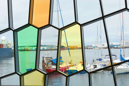 Facade detail of Harpa Concert Hall with view of port Reykjavik, across the windows horizontalのeditorial素材