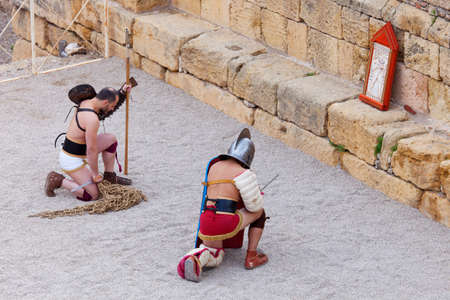 Tarragona, Spain - May 19, 2013: Gladiators on the arena of Roman Amphitheater on May 19, 2013 in Tarragona, Spain. Every year, the historic recreation program TarracoViva recreates a gladiators fightのeditorial素材