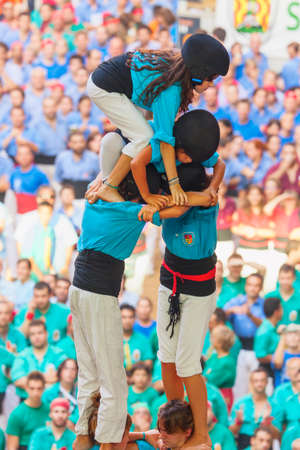 Tarragona, Spain - October 6, 2012: Members of the \"Castellers de Terrassa\", build a traditional human tower at the Tarragona during celebrations in Tarraco Square Sand castle contest, October 6, 2012, Tarragona, Spain.  A perfect example of teamwork, uのeditorial素材