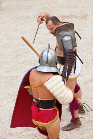 Tarragona, Spain - May 19, 2013: Gladiators on the arena of Roman Amphitheater on May 19, 2013 in Tarragona, Spain. Every year, the historic recreation program TarracoViva recreates a gladiators fightのeditorial素材