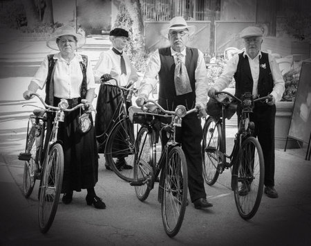 Two elderly couple dressed in historical costume pushing their old bicycles  Festival Bled,...
