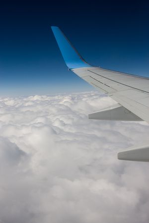 wing plane over cloudsの写真素材