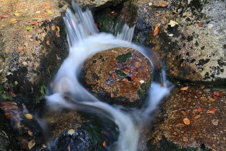Circular waterfall stream of mountain creek in autumn in Jizera mountains in Czech republicの写真素材