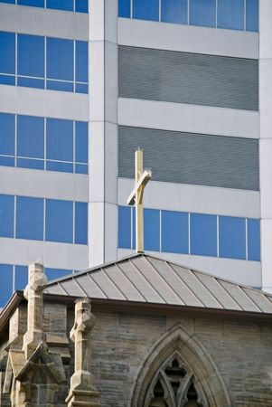 A vey old landmark church against a very modern buildingの写真素材