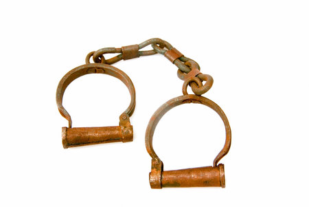 A pair of old and rusted vintage handcuffs. 