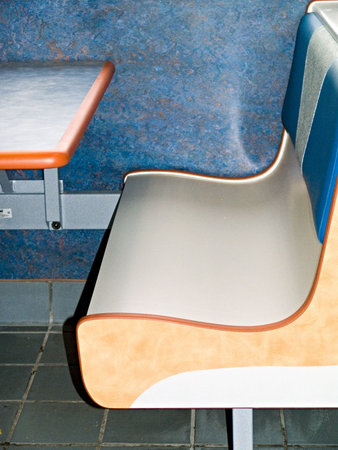 Corner of a table and bench in a fast food resturant.