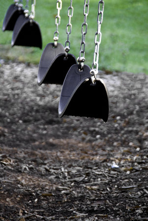 Sling type swings made of leather like or rubber material hung by chains. の写真素材