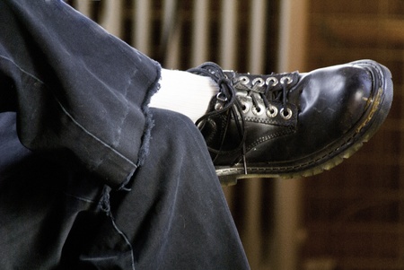 A workman resting after a long day at work showing the worn out jeans and shoes. の写真素材