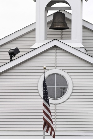 A bell in a tower, a round window, and American flag. の写真素材