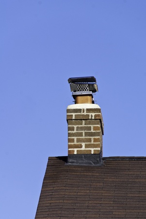 An edge of a roof with a chimney and screen. の写真素材
