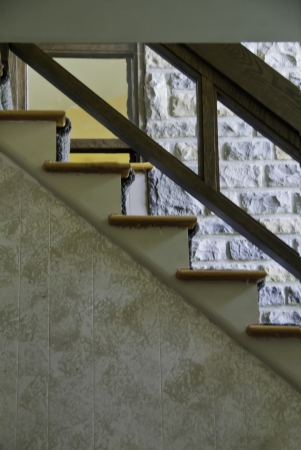 Stair steps with a banister against a block wall. の写真素材