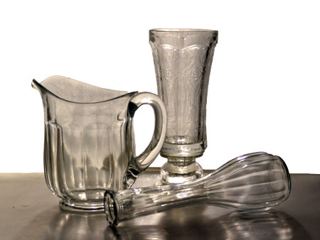 Glass containers of pitchers and vases in a gray light. の写真素材