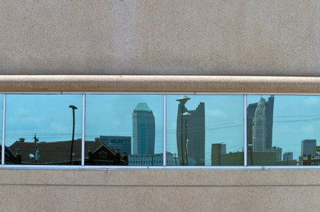 The refelctions of a city skyline in a wall of window.