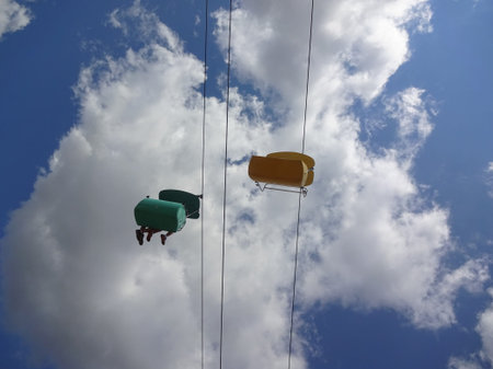 one of the fun rides at a state fair, bucket on line and feed dangling as the ride progressed.