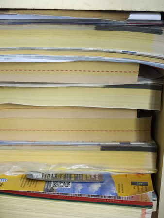 books on a shelf, with telephone books and adsのeditorial素材