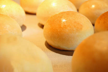 Freshly Baked Golden Rolls on a Panの写真素材