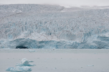 Beautiful view of the clouds over snowy mountains and ice floes in the Arctic