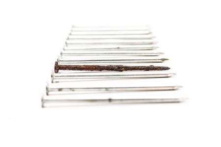 Old rusty nail between new ones. Weak point metaphorの写真素材