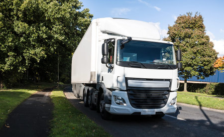 White lorry on the road makes a delivery
