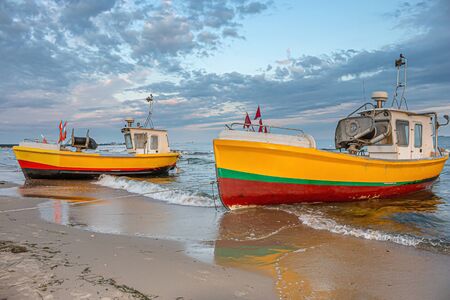 Two small fishing boats on the beachの写真素材