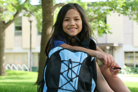 Eight year old girl ready for first day of school. Part asian,scandinavian descent.