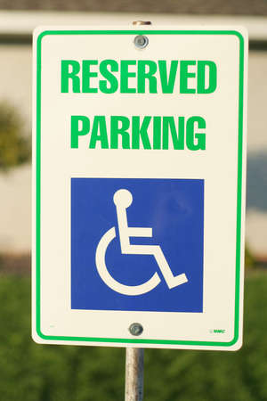 Handicap reserved parking sign on postの写真素材