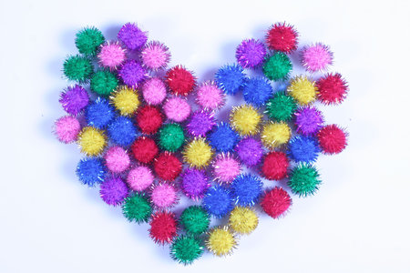 Multi- colored Heart formed from small color puff ballsの写真素材