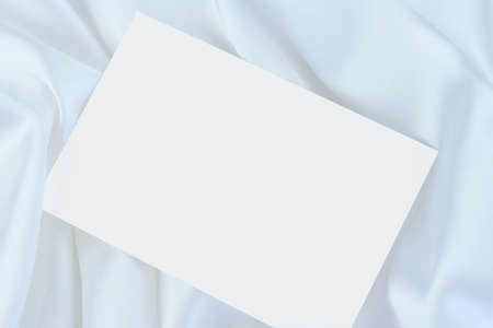 White blank card on white satinの写真素材