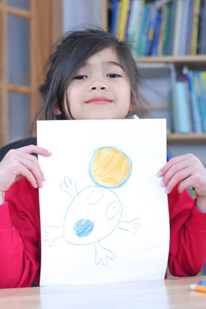 Girl showing off her drawing