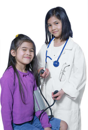 Two girls playing doctor and patientの写真素材