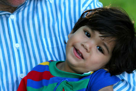 Happy toddler in father,s armsの写真素材