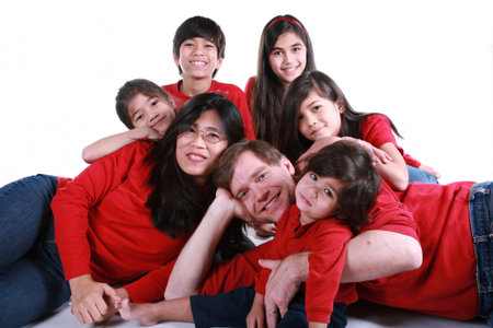 Large family of seven in red shirts and jeans isolated on whiteの写真素材
