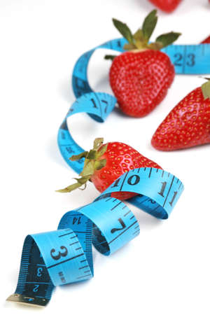 Healthy eating with fruit, strawberries. Berries with tape measure. health concept.の写真素材