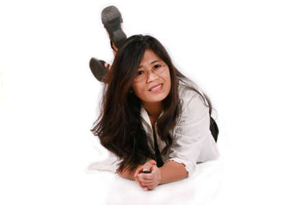 Asian woman in thirties lying on floor smilingの写真素材